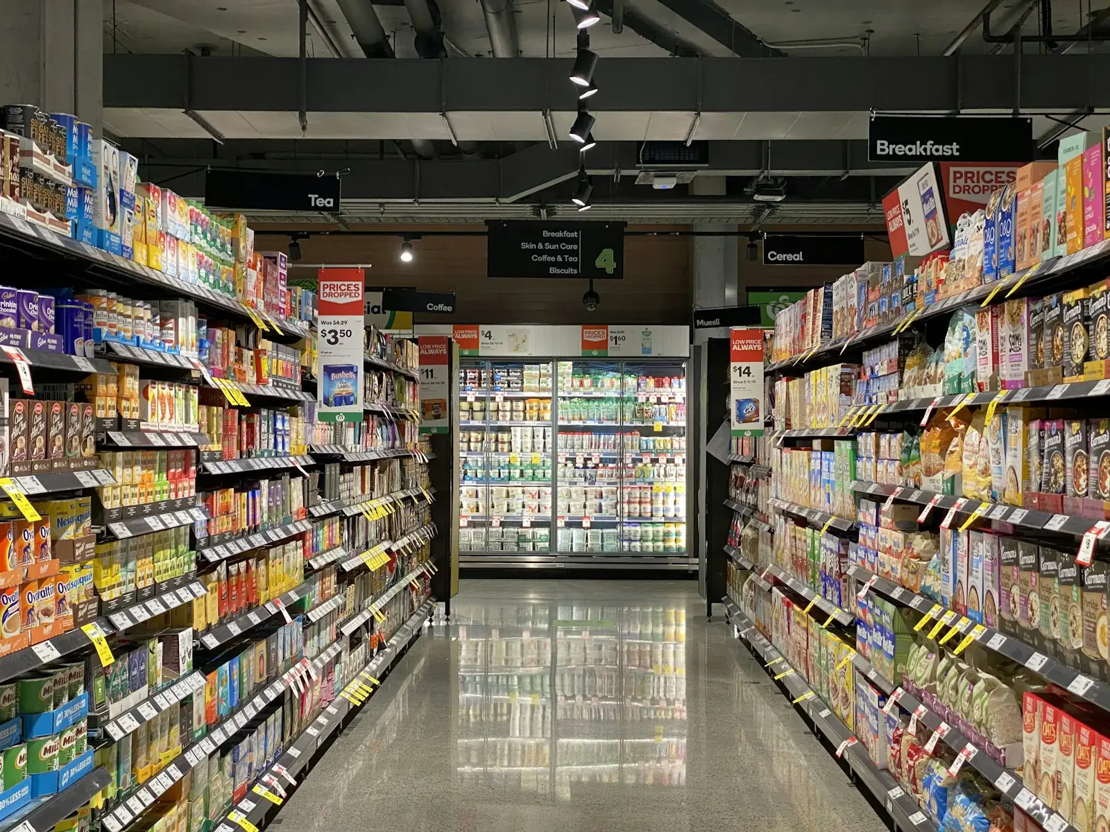 Store aisle with stocked shelves and coolers
